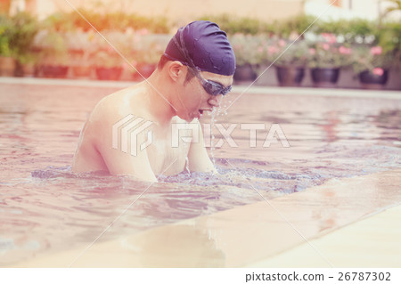 man finishing swim training,getting out of pool 26787302