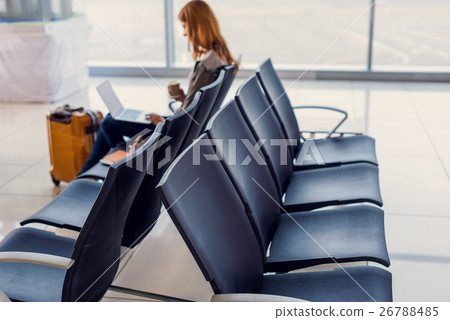 Beautiful girl using laptop in airport 26788485