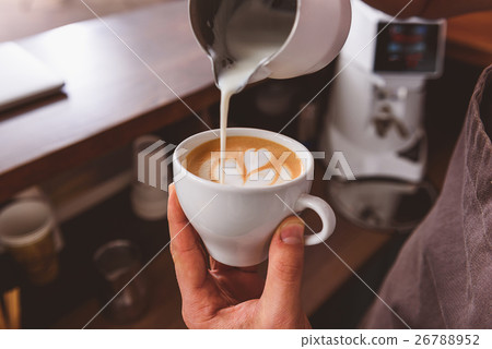 man showing how to make coffee art 26788952
