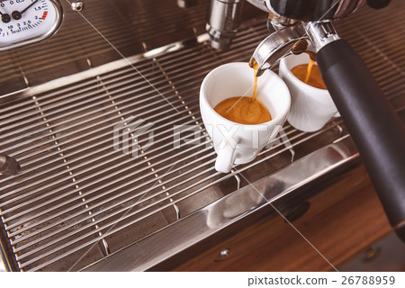 Hot espresso prepared in cafe 26788959