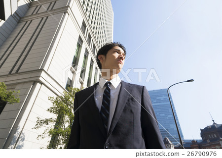 Businessman Looking far away Low angle Blue sky Copy space outside Tokyo Otemachi Marunouchi Tokyo station front Businessman Looking far away Low angle Blue sky Copy space outside Tokyo Otemachi Marunouchi Tokyo station front 26790976