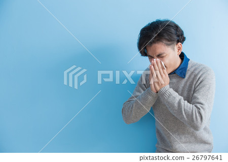 man is sick and sneezing 26797641