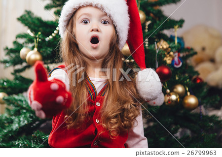 Surprised cheerful girl in red christmas hat 26799963