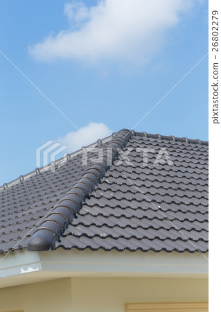 black roof tiles on house with blue sky black roof tiles on house with blue sky 26802279