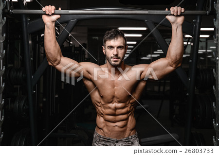 Strong and handsome athletic young man muscles abs and biceps. 26803733