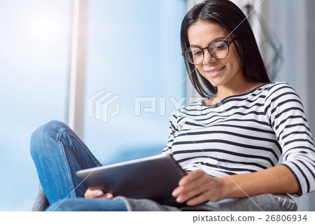 Involved pleasant woman using the tablet at home 26806934