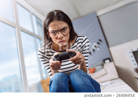 Involved young woman playing games at home 26806958
