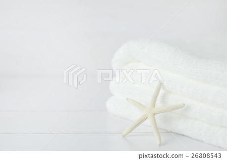 Starfish and pile of white towel on white wooden 26808543