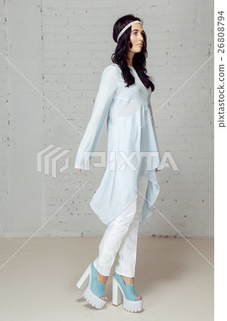 Model in studio posing to the photograther 26808794