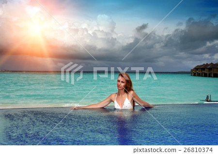 beautiful woman in the pool before the sea at suns beautiful woman in the pool before the sea at suns 26810374