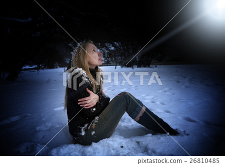 beautiful frozen woman sits in snow in the night p 26810485