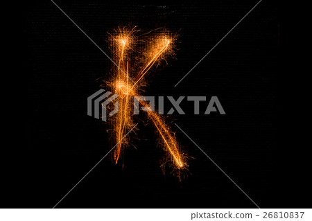 Letter K made of sparklers on black 26810837
