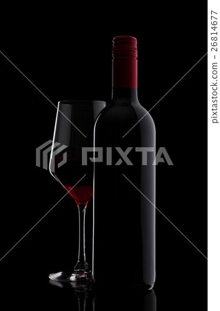 Glass of red wine with bottle close up on black 26814677
