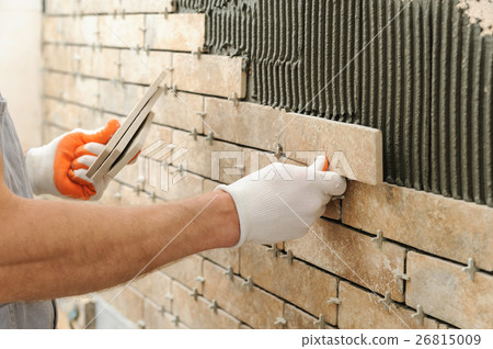 Installing the tiles on the wall. Installing the tiles on the wall. 26815009