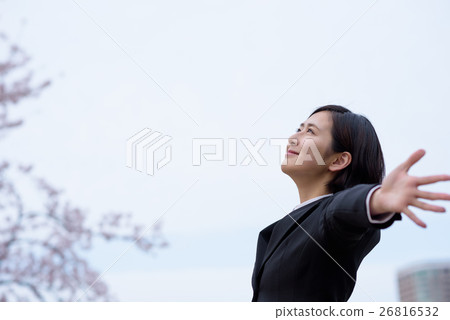 A female business woman of a new employee who spreads his hands toward the sky A female business woman of a new employee who spreads his hands toward the sky 26816532