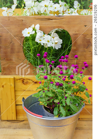The flowers in vase on wooden background. The flowers in vase on wooden background. 26819206