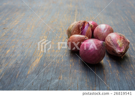 Red onion isolated on wood background. 26819541