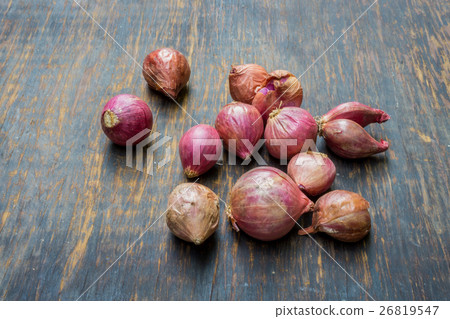 Red onion on rustic background. 26819547
