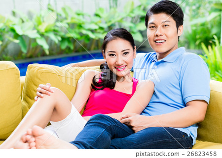 Chinese woman and man of sofa in their home 26823458