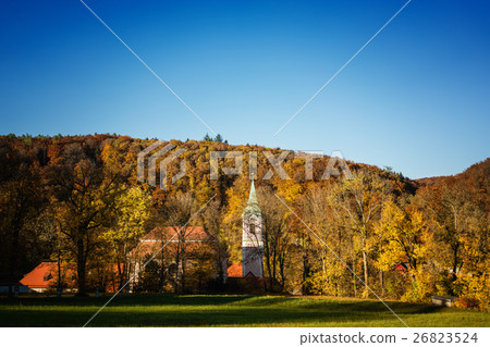 Little baroque church or chapel in colorful forest 26823524