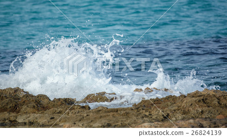 Detailed view of waves breaking on a stony beach Detailed view of waves breaking on a stony beach 26824139