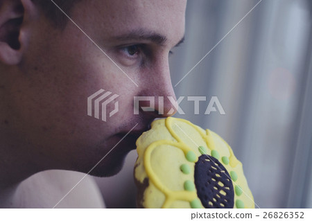 man sniffing a beautiful and festive gingerbread man sniffing a beautiful and festive gingerbread 26826352