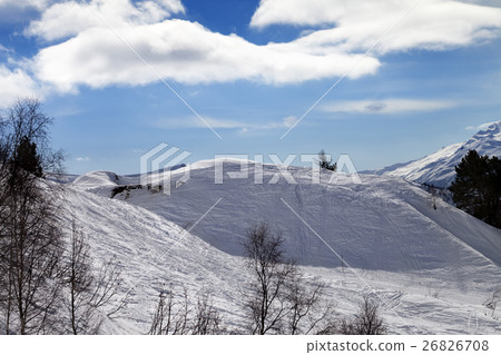 Off-piste slope with traces from ski and snowboard 26826708