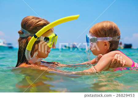Mother with child swim underwater with fun in sea 26829453