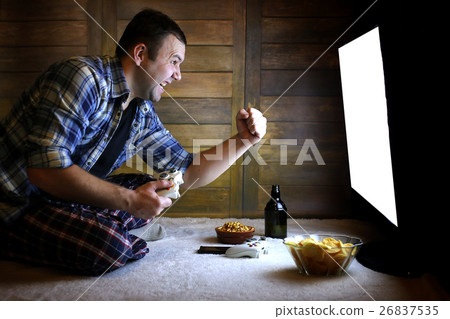 man playing on a console on the joystick 26837535