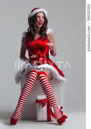 Girl unwrapping christmas present 26838360