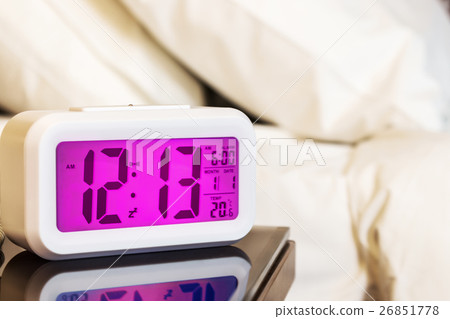 digital alarm clock on the bedside table  26851778