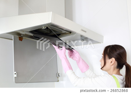 A woman cleaning range hood A woman cleaning range hood 26852868