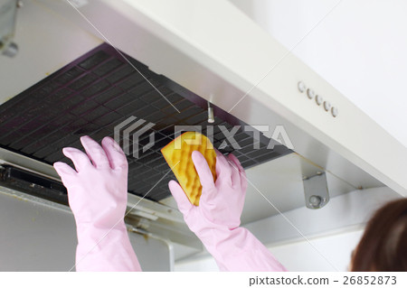 A woman cleaning range hood 26852873