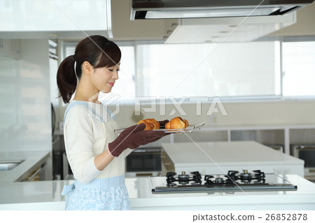 A woman who bakes bread 26852878