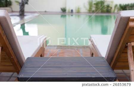 wood table and pool chair at swimming pool wood table and pool chair at swimming pool 26853679