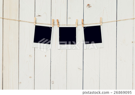 Three (3)blank photo frame hanging on white wood 26869095