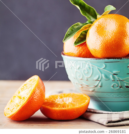 Juicy Mandarin Fruit in a Bowl on Background 26869181