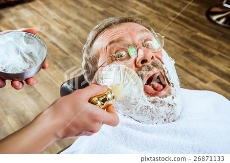 The senior man visiting hairstylist in barber shop 26871133