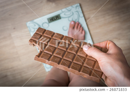 Overweight woman standing on scale 26871833