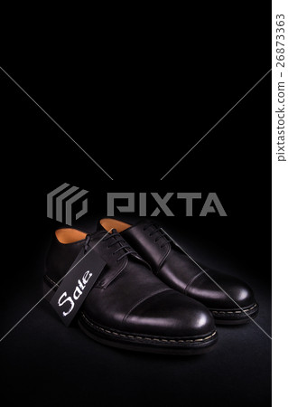 Sale sign. Black oxford shoes on  background. Back 26873363