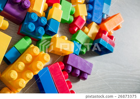 Bright plastic construction blocks on background Bright plastic construction blocks on background 26873375