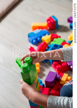Close up of child hand playing with plastic 26873379