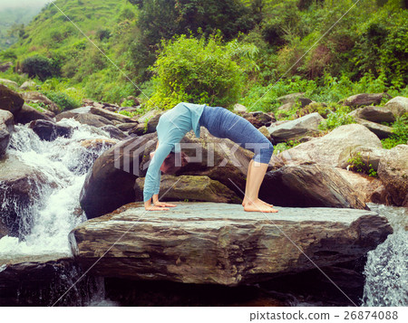 Woman doing Ashtanga Vinyasa Yoga asana Urdhva 26874088