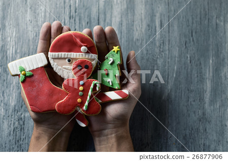 man with christmas cookies in his hands 26877906