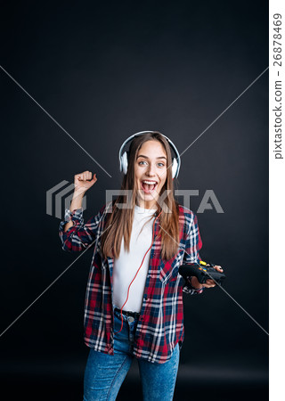 Overjoyed smiling woman playign video games Overjoyed smiling woman playign video games 26878469