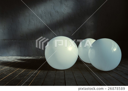 Three big balloons lying in the dark lighted room Three big balloons lying in the dark lighted room 26878589
