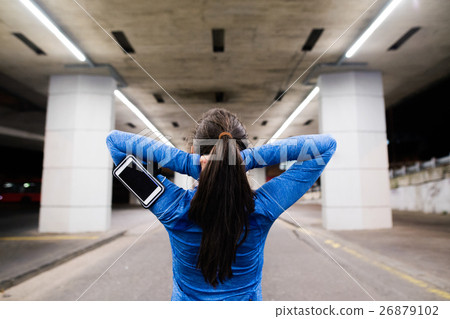 Young runner under the bridge in the evening 26879102