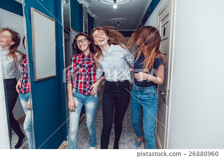 Pretty girls walk down the hall in hostel and fun. Pretty girls walk down the hall in hostel and fun. 26880960