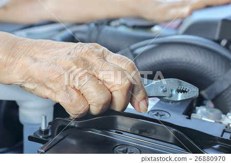 Elderly woman repairing her car Elderly woman repairing her car 26880970