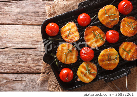 Tasty roasted potatoes and tomatoes with rosemary Tasty roasted potatoes and tomatoes with rosemary 26882261